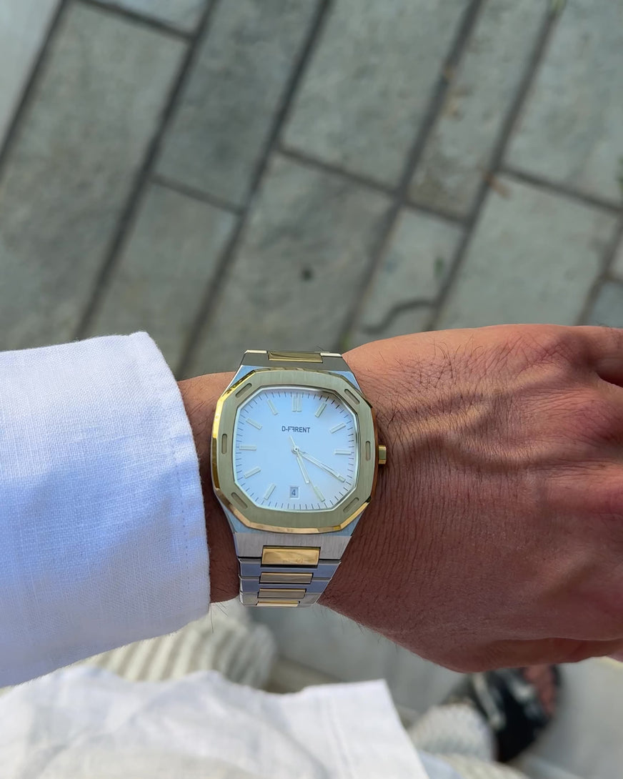 D-FFRENT The Aura Two Tone gold and silver men's watch with white dial on wrist.