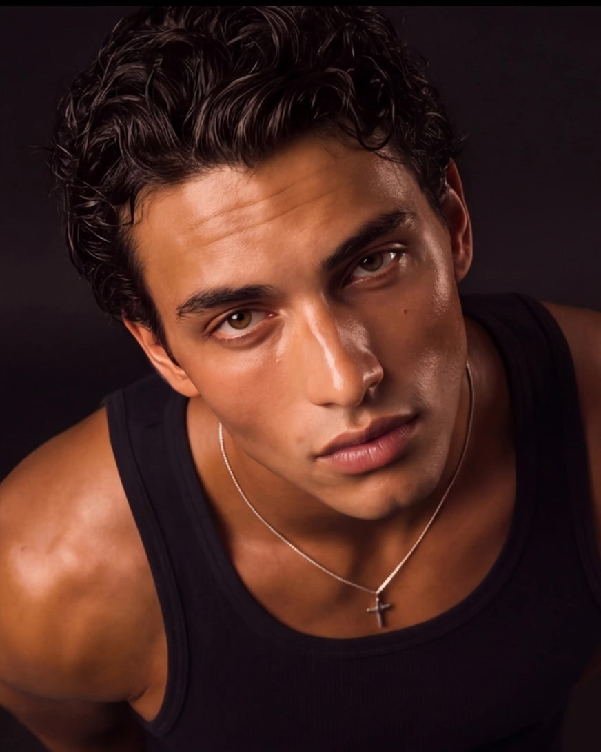 Men's cross pendant necklace worn with a black tank top
